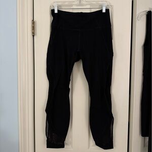 Athleta 7/8 length black leggings - mesh detailing on the side of the leg